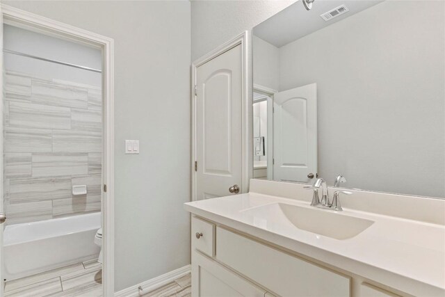 full bathroom featuring vanity, toilet, and tiled shower / bath