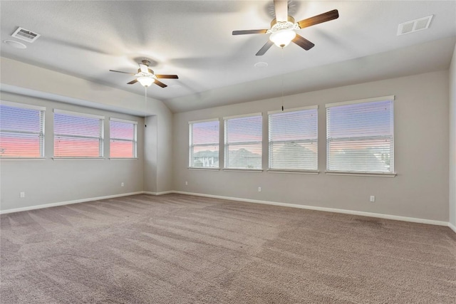 unfurnished room with vaulted ceiling, ceiling fan, and carpet floors