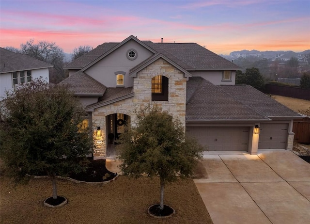 french country style house featuring a garage