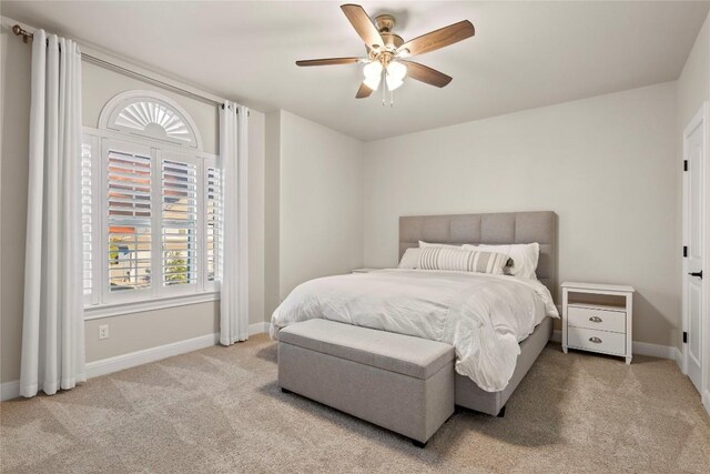 bedroom featuring light colored carpet and ceiling fan