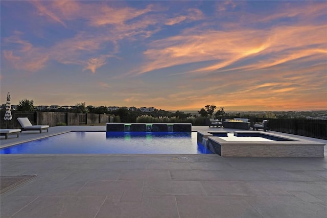 2513 Long Lasso Pass, Leander, TX 78641 - pool at dusk with a patio area and a pool with connected hot tub
