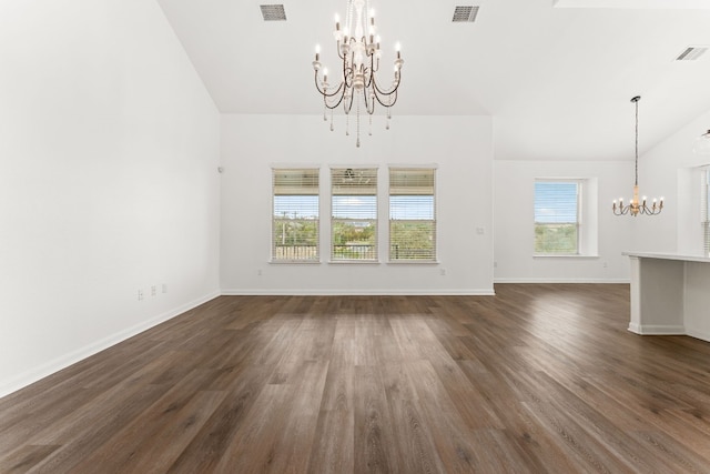 unfurnished living room featuring dark hardwood / wood-style flooring, a notable chandelier, and lofted ceiling