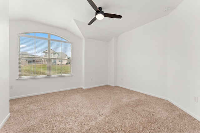 unfurnished room with vaulted ceiling, light colored carpet, and ceiling fan