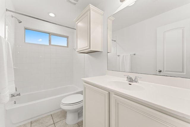 full bathroom with tile patterned flooring, vanity, tiled shower / bath combo, and toilet