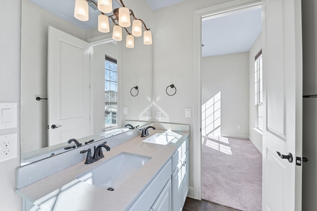 bathroom featuring vanity, a chandelier, and a healthy amount of sunlight