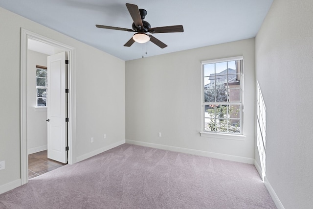 unfurnished room featuring light colored carpet and ceiling fan