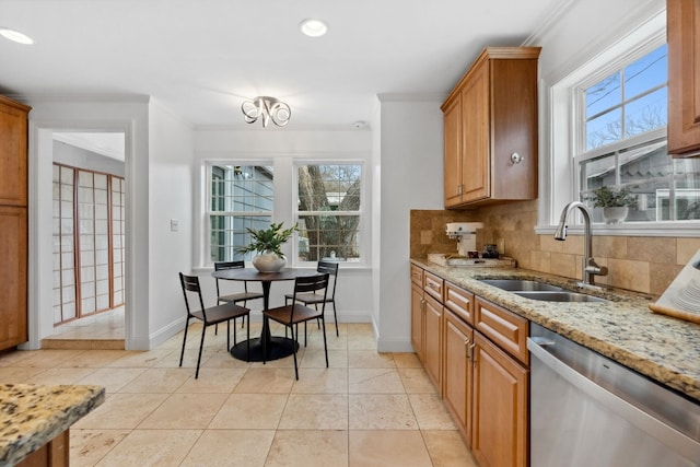 2108 Glendale Pl, Austin, TX 78704 - kitchen featuring stainless steel dishwasher, a sink, ornamental molding, backsplash, and light stone countertops
