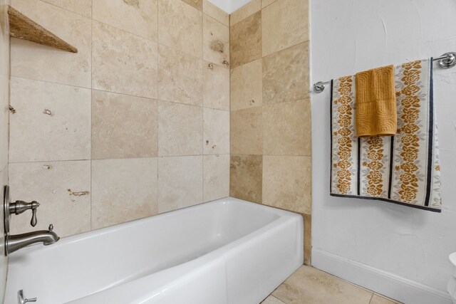 bathroom featuring tile patterned flooring and a tub