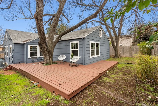 rear view of property with a deck and central air condition unit