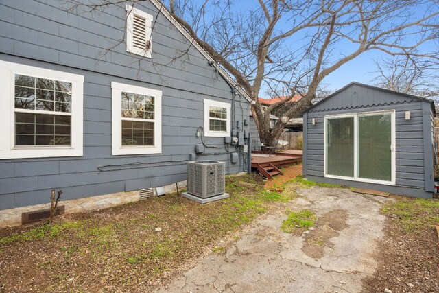 view of side of home with central AC unit