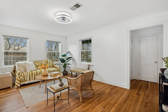 2108 Glendale Pl, Austin, TX 78704 - sitting room with ornamental molding, visible vents, baseboards, and hardwood / wood-style flooring