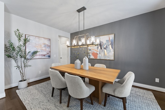 dining space featuring dark hardwood / wood-style floors and a notable chandelier