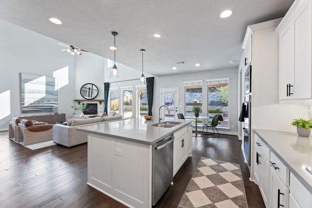 kitchen featuring white cabinetry, sink, a center island with sink, and appliances with stainless steel finishes