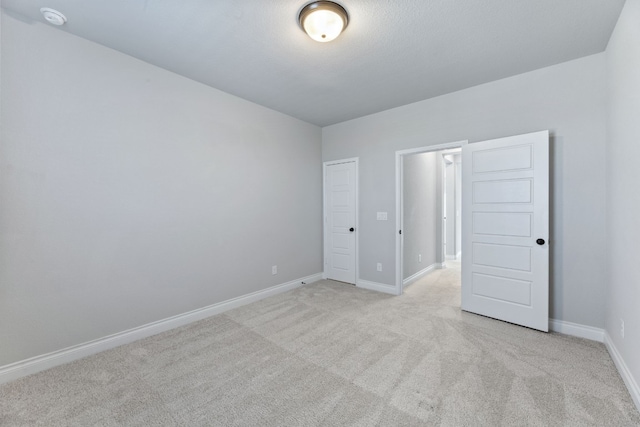 unfurnished bedroom with light carpet