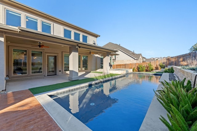 view of swimming pool featuring a patio and ceiling fan