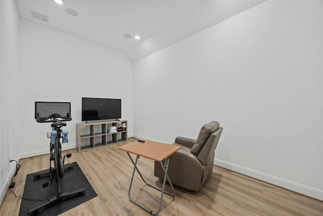 workout area with lofted ceiling and light wood-type flooring