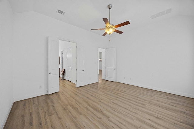 unfurnished bedroom featuring ceiling fan, lofted ceiling, and light hardwood / wood-style floors