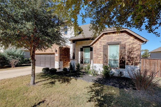 view of front of property with a garage and a front yard