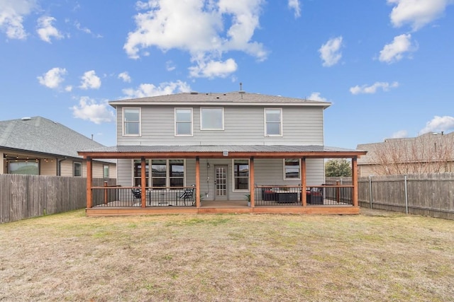 back of property featuring a lawn