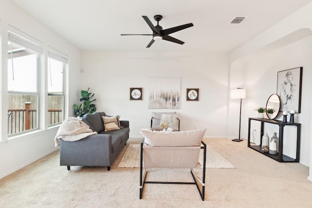 living room featuring light colored carpet and ceiling fan