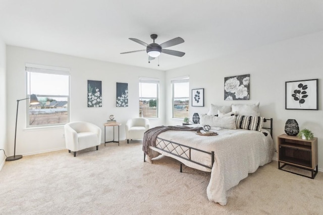 carpeted bedroom with multiple windows and ceiling fan