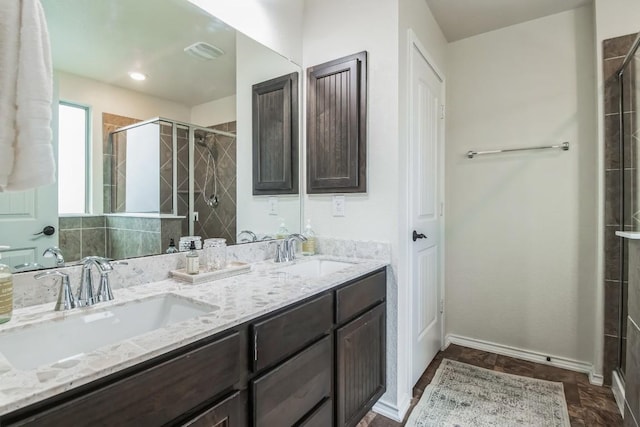 bathroom featuring vanity and an enclosed shower