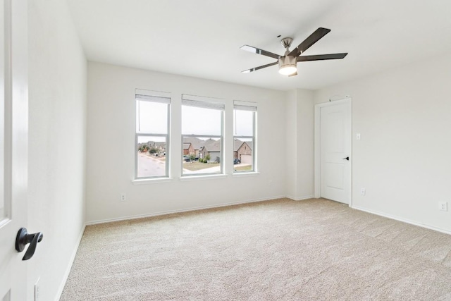 carpeted empty room featuring ceiling fan