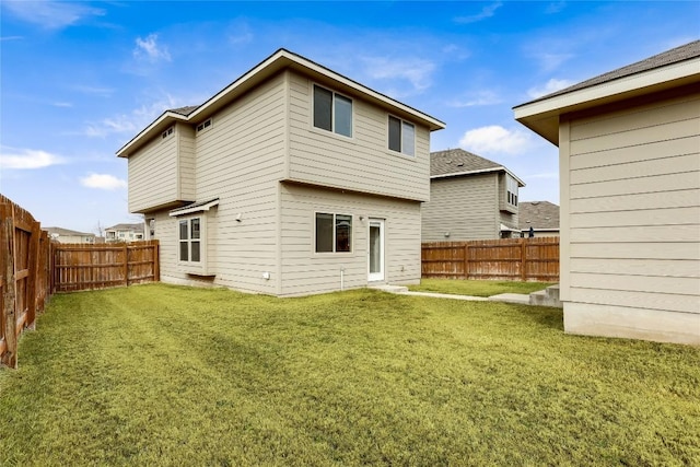 rear view of property featuring a yard