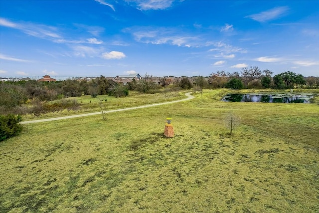 view of property's community featuring a yard and a water view