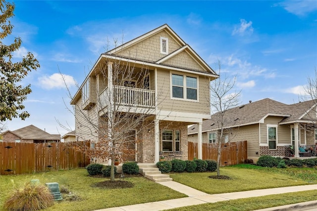 view of front of property with a balcony and a front lawn