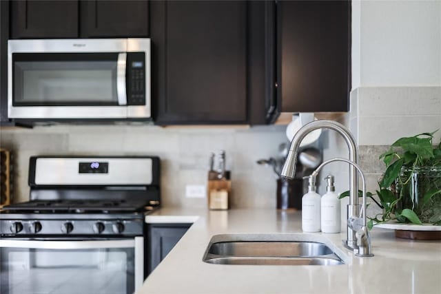 kitchen with sink, decorative backsplash, and stainless steel appliances