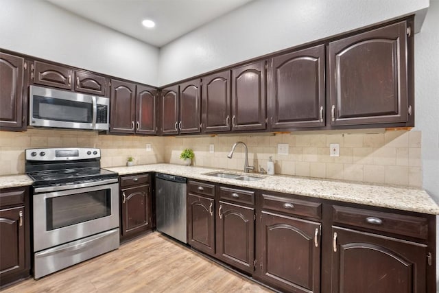 kitchen featuring appliances with stainless steel finishes, sink, and dark brown cabinets