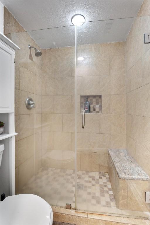 bathroom featuring an enclosed shower and toilet