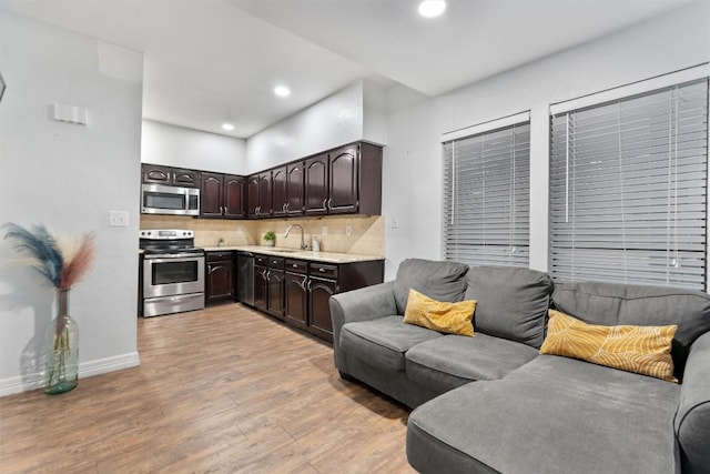 living room with sink and light wood-type flooring