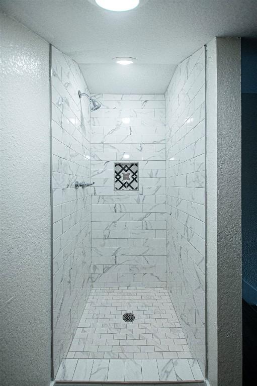 bathroom with tiled shower