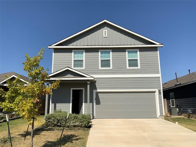 view of front of home with a garage and central AC unit