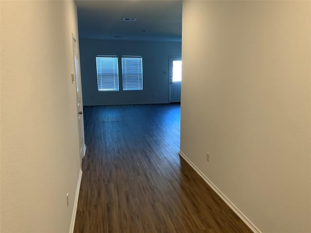 corridor with dark hardwood / wood-style floors