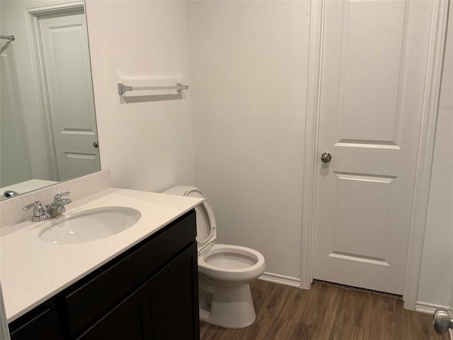 bathroom with vanity, hardwood / wood-style floors, and toilet