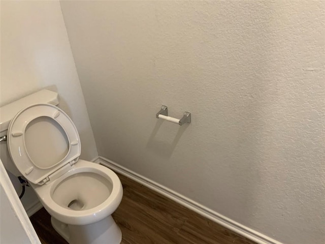 bathroom featuring hardwood / wood-style flooring and toilet