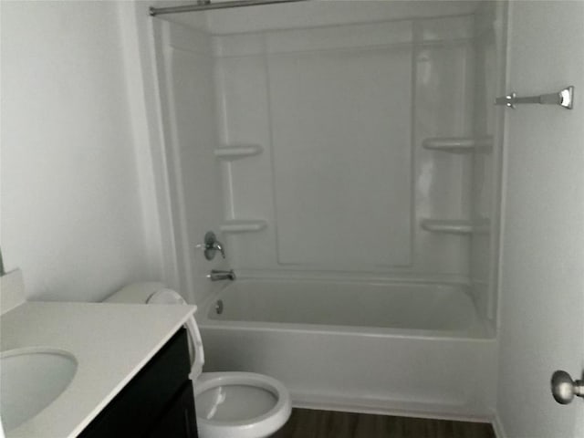 full bathroom with vanity, wood-type flooring, shower / tub combination, and toilet