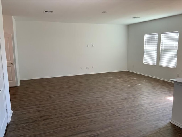 unfurnished room featuring dark hardwood / wood-style floors