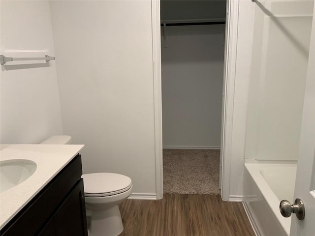 bathroom featuring vanity, toilet, and hardwood / wood-style floors