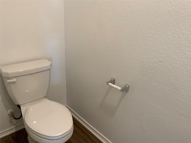 bathroom with hardwood / wood-style floors and toilet