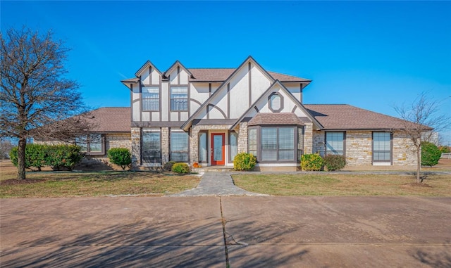 tudor-style house with a front yard