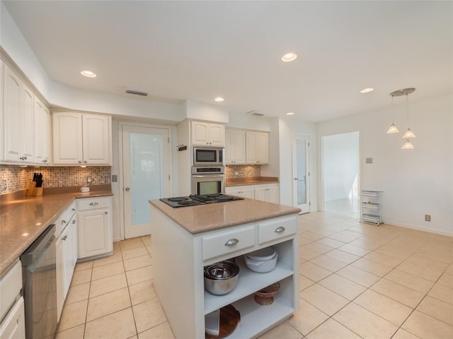 kitchen featuring hanging light fixtures, white cabinetry, appliances with stainless steel finishes, and light tile patterned floors