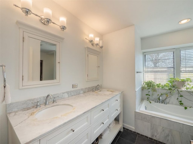 bathroom featuring vanity, tiled bath, and tile patterned flooring