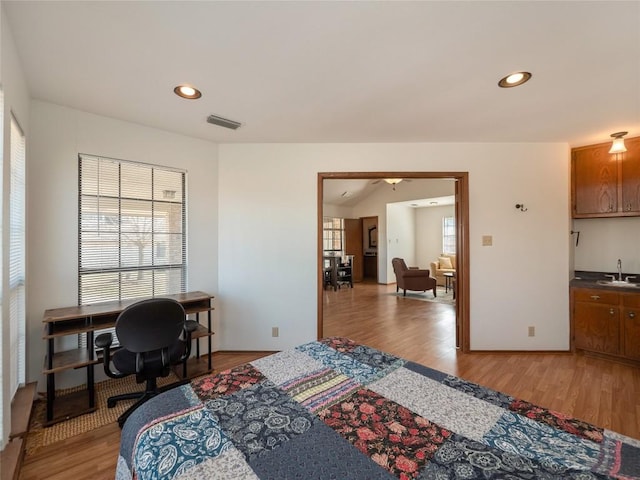 bedroom featuring sink and hardwood / wood-style floors