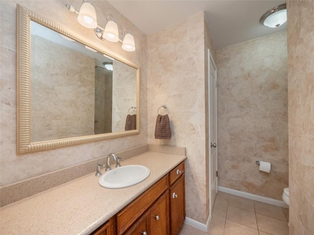 bathroom with vanity, tile patterned floors, and toilet