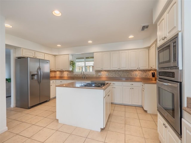 1822 Rowe Loop, Pflugerville, TX 78660 - kitchen with appliances with stainless steel finishes, light tile patterned flooring, decorative backsplash, and recessed lighting