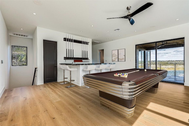 rec room featuring bar, ceiling fan, pool table, and light hardwood / wood-style floors